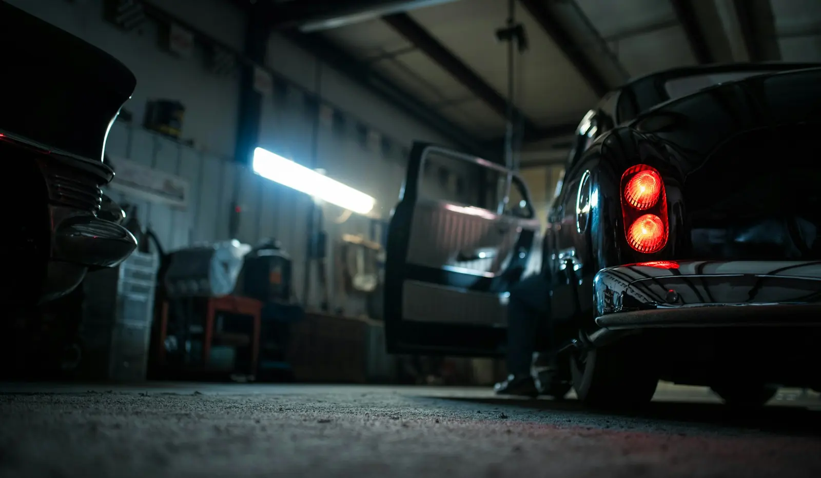 Mechanic shop bay with vehicles and tools